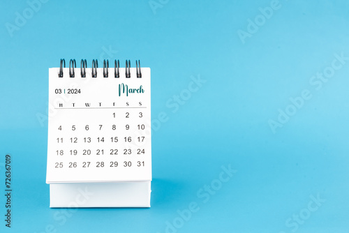 March 2024 mini desk calendar on blue color background.