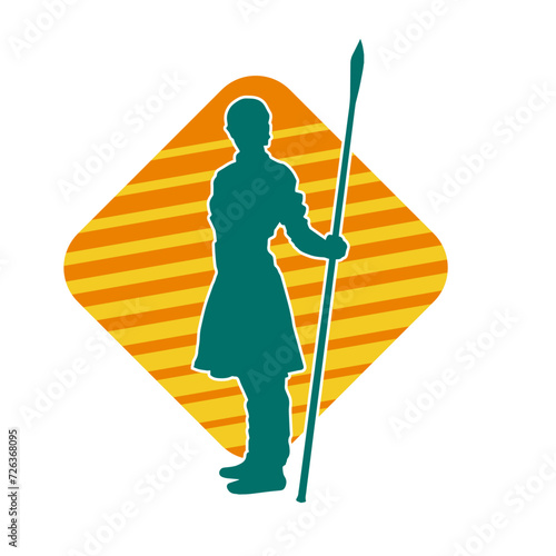 Silhouette of a wushu martial artist in action pose with a spear weapon. Silhouette of a fighter carrying a spear weapon.