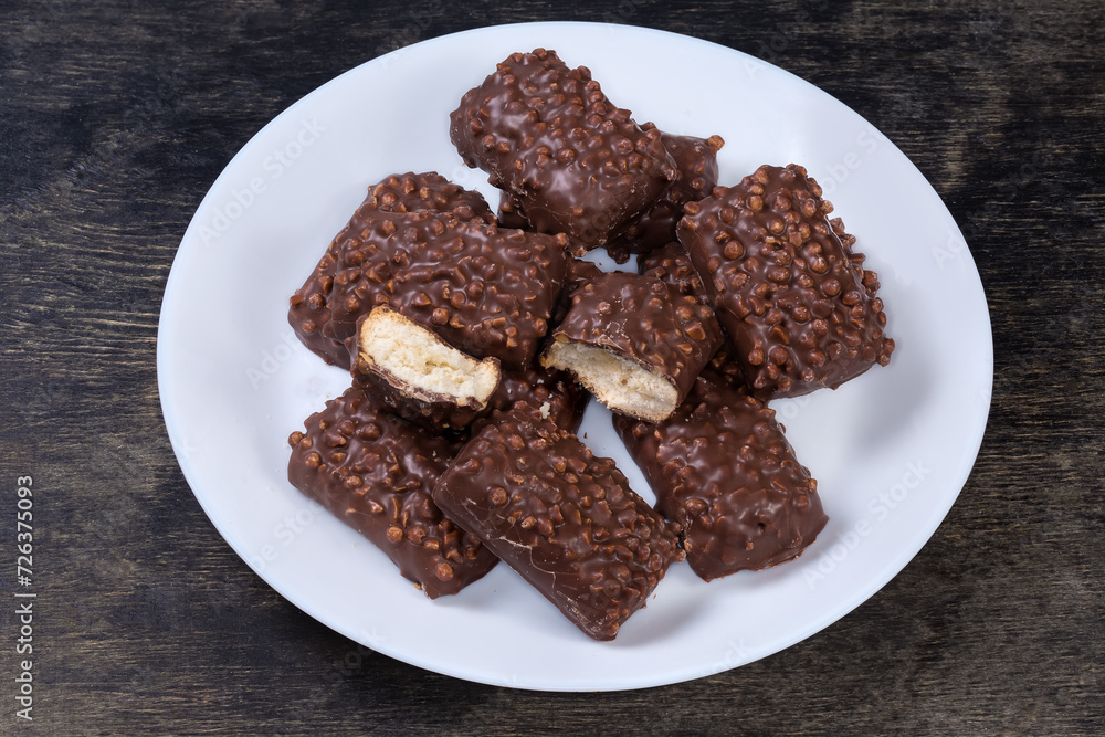 Cookies with rice balls and milk chocolate coating on dish Cookies with rice balls and milk chocolate coating on dish
