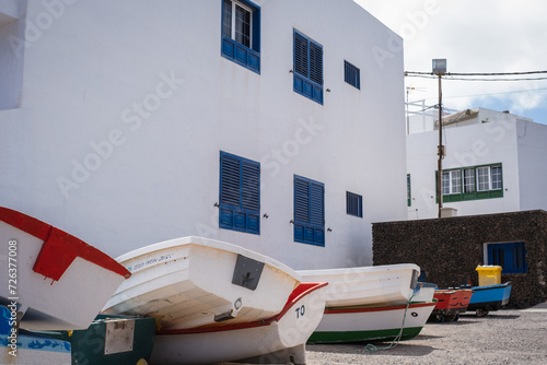 Typical white house with blue windows in the village of Arrieta with boats. Lanzarote, Canary Islands, Spain photo
