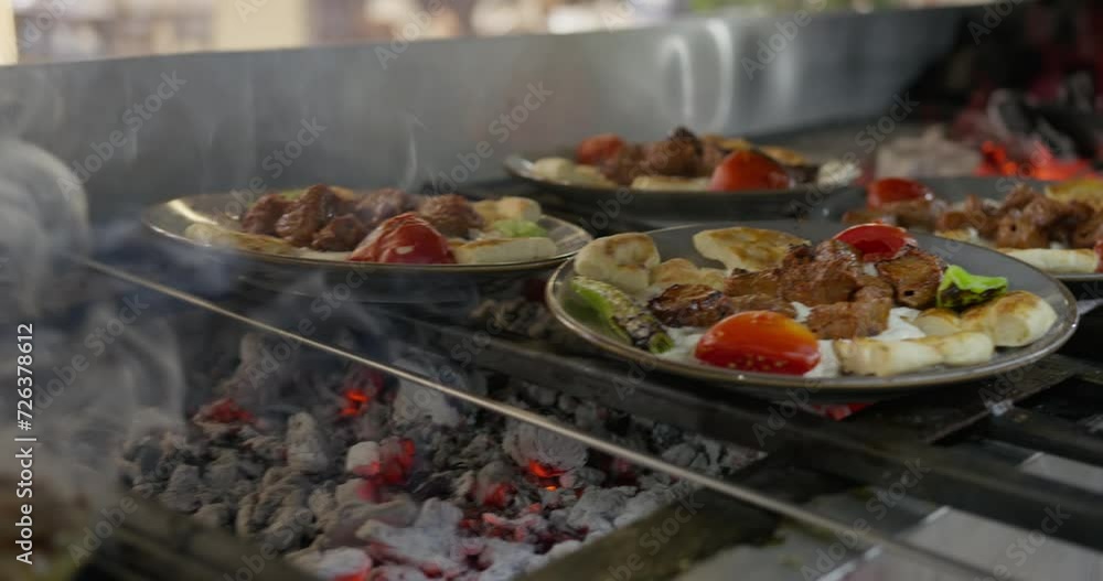 Frying cutlets in the hotel kitchen next to a served plate of food. Frying cutlets in the hotel kitchen next to a served plate of food.