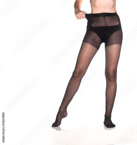 Woman wearing black nylon tights standing isolated on white background. Front view