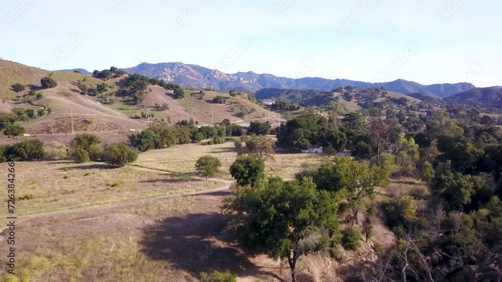 Panning Aerial shot of Santa Monica Mountains in Los Angeles, California at sunset on a warm sunny day Panning Aerial shot of Santa Monica Mountains in Los Angeles, California at sunset on a warm sunny day
