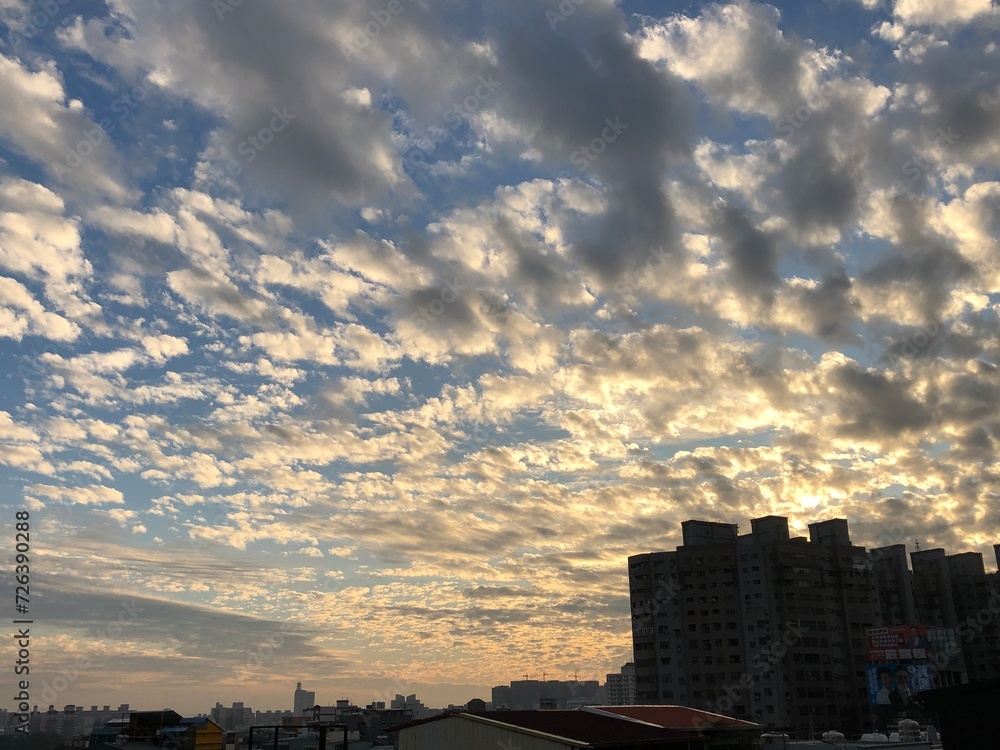 Fototapeta premium Majestic clouds over the urban skyline with tall buildings