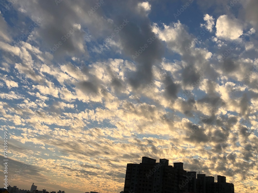Majestic clouds over the urban skyline with tall buildings