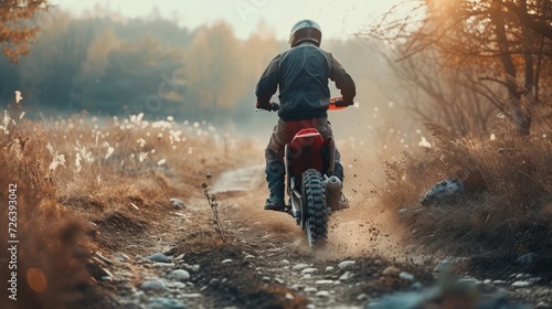 Motocross. Man, professional motorcyclist in full moto equipment riding crops enduro bike on mountain road at sunset. Generative AI. Concept of motosport, speed, hobby, journey, activity. In action photo