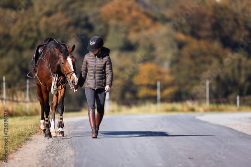 Girl rider goes riding with her horse ready to ride.