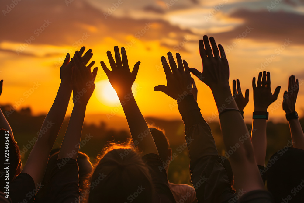 Unity and Celebration: Silhouetted Hands Raised High Against a Vibrant Sunset Sky - Inspirational Themes