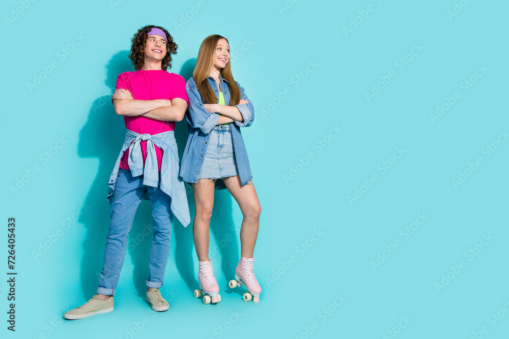 Full body photo of young two best friends teenage girl in roller skates looking with boy new rollerdrome isolated on blue color background Full body photo of young two best friends teenage girl in roller skates looking with boy new rollerdrome isolated on blue color background