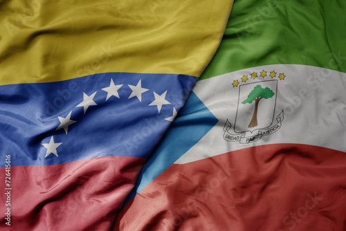 big waving national colorful flag of equatorial guinea and national flag of venezuela . macro