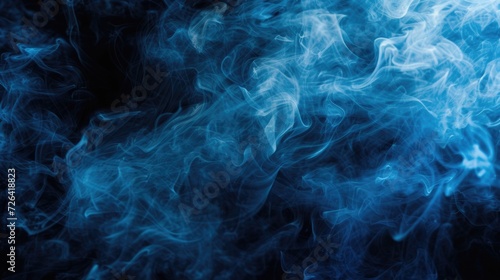 Close-up shot of blue smoke on a black background. Can be used to create a mysterious or abstract atmosphere in designs or presentations