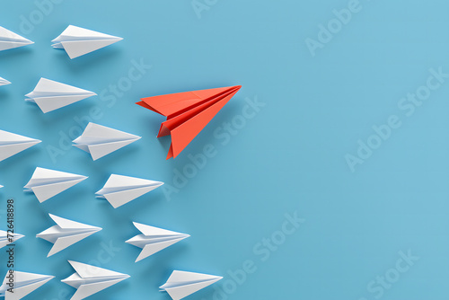 A standout red paper plane leads a formation of white ones against a vibrant blue background  symbolizing leadership and innovation. This image is suitable for various themes such as business  educa