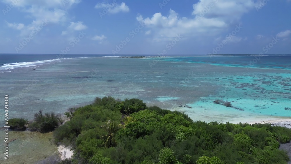 Drone view of paradise islands of the Maldives with coral reefs under the waves of blue the Indian Ocean. Drone view of paradise islands of the Maldives with coral reefs under the waves of blue the Indian Ocean.