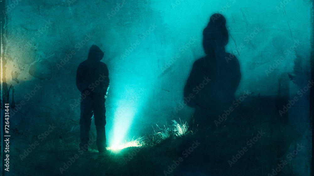A horror concept of a ghost like spooky Victorian woman. Looking at a mysterious hooded man silhouetted at night. With a grunge, blurred double exposure edit. A horror concept of a ghost like spooky Victorian woman. Looking at a mysterious hooded man silhouetted at night. With a grunge, blurred double exposure edit.