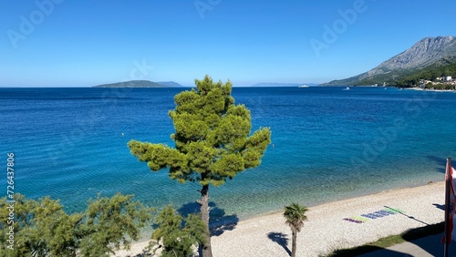 blue maybe green trees on shore  island in Croatia visible in distance