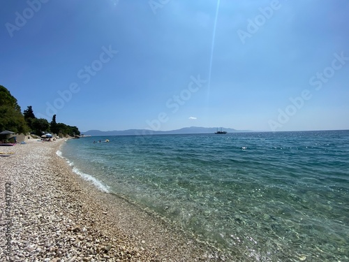 blue maybe green trees on shore, island in Croatia visible in distance