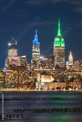 Illuminated New York City skyscrapers at night from across the Hudson River. Cityscape of West Village and Midtown Manhattan
