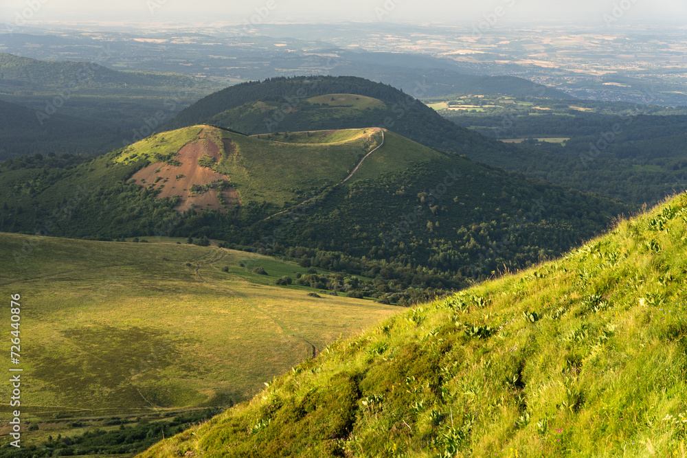 Obraz premium Auvergne vulcan since top of the Puy de Dome vulcan at sunset. Dramatic light landscape. Clermont Ferrand, France.