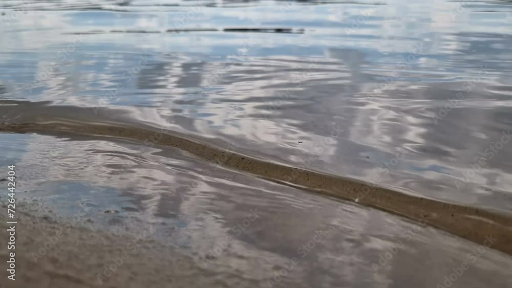 Sandy beach with waves. Recreation at the sea, river Sandy beach with waves. Recreation at the sea, river