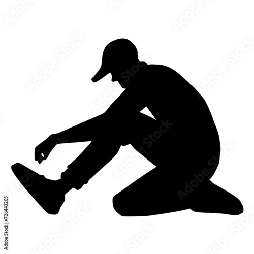 silhouette of a person tying shoes