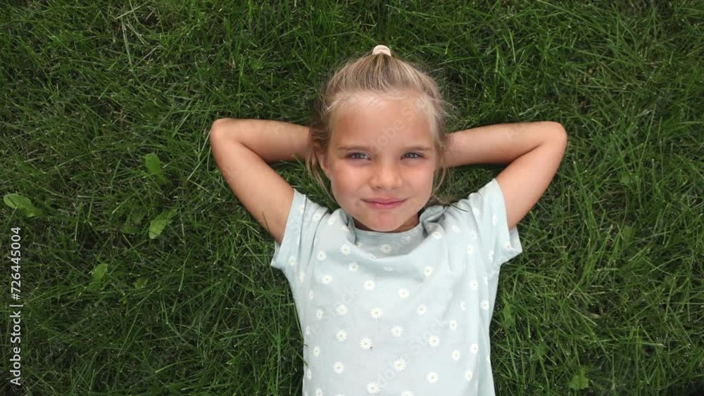 laughing child girl lies on green grass. laughing child girl lies on green grass.