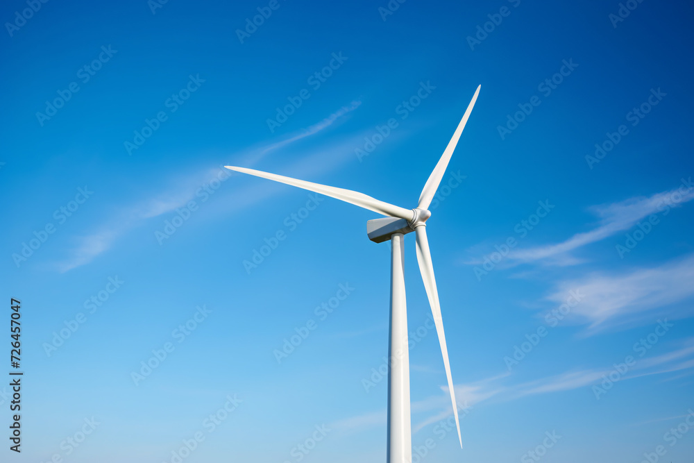 Wind mill turbine in front of blue sky