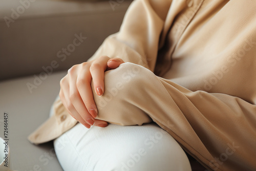 Pregnant woman with pillow on sofa at home, closeup