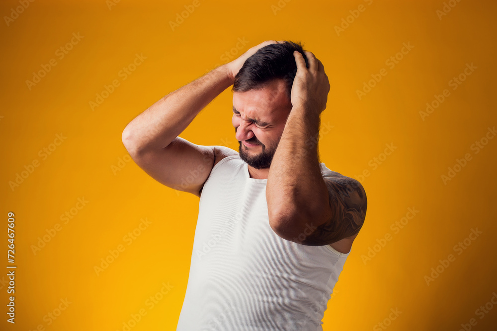 Man suffering from headache desperate and stressed because pain and migraine. Hands on head. People, healthcare and medicine concept Man suffering from headache desperate and stressed because pain and migraine. Hands on head. People, healthcare and medicine concept