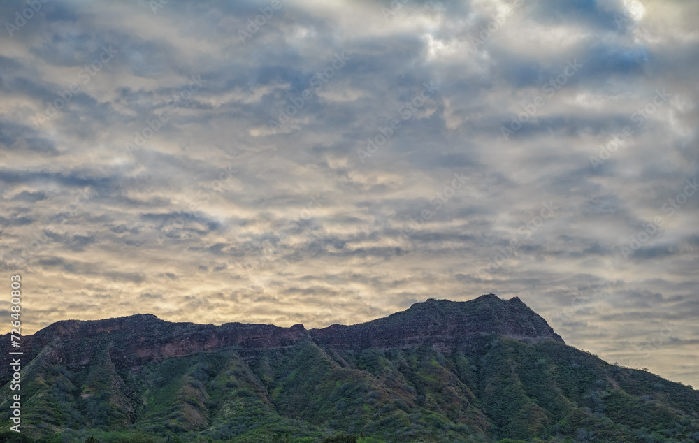Fototapeta premium Clouds over a Mountain at Sunrise.