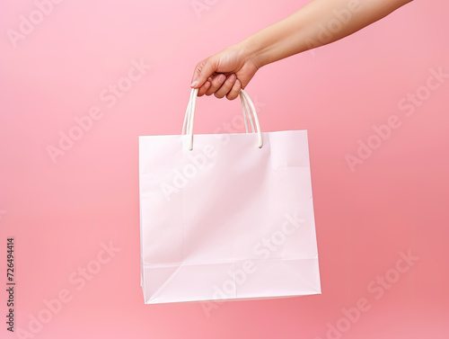 Hand Holding Blank White Tote Bag Against Pink Background - Generative AI