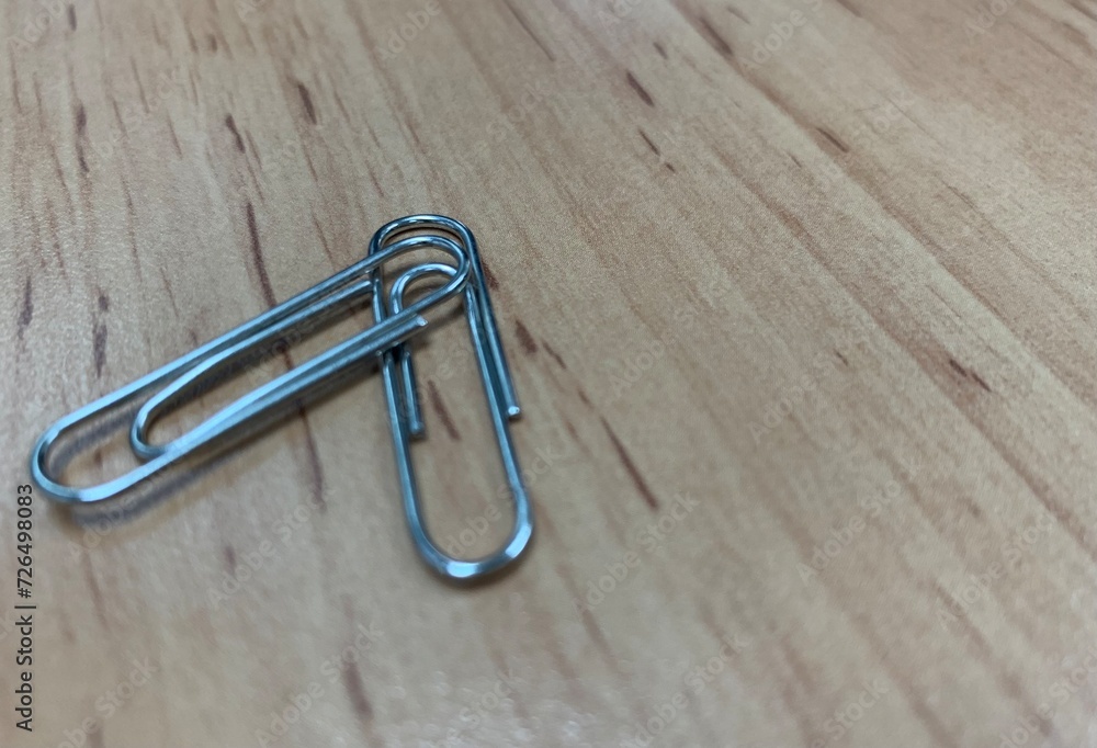 paper clips on wooden brown texture background, two, together, couple paper clips on wooden brown texture background, two, together, couple