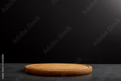 Wooden board for cutting on a black background.