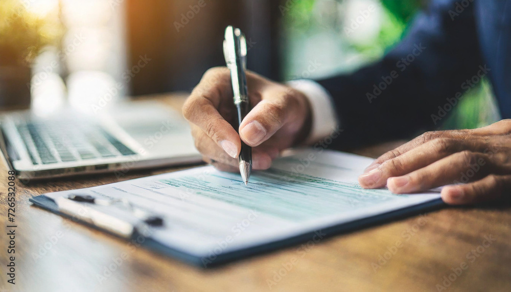 hand holding pen, signing financial check and contract with focus, symbolizing commitment, legality, and financial agreement hand holding pen, signing financial check and contract with focus, symbolizing commitment, legality, and financial agreement