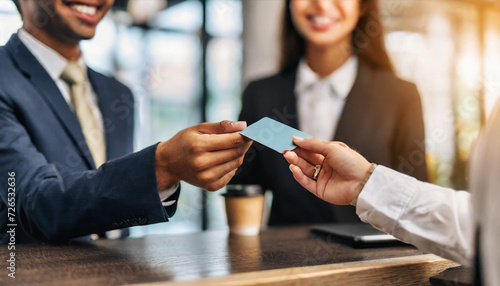 hands passing credit card from customer to receptionist, symbolizing secure transactions and financial interactions in a modern business setting
