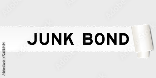 Ripped gray paper background that have word junk bond under torn part