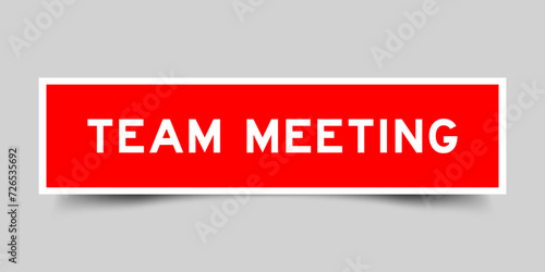 Sticker label with word team meeting in red color on gray background