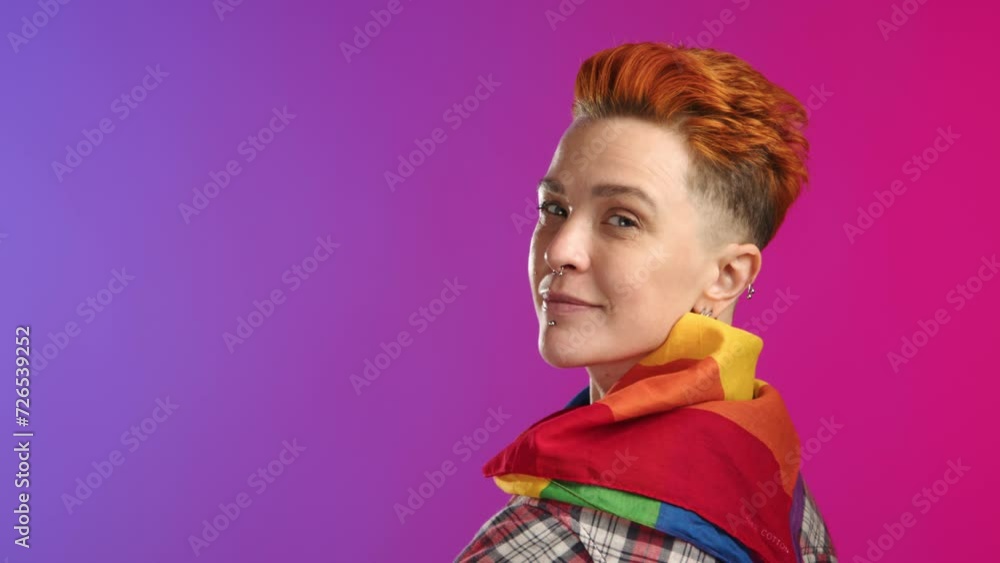 A young woman identifying as a lesbian turns towards the camera, showcasing a rainbow LGBT flag with a genuine smile, set against a dynamic pink and purple gradient backdrop. Camera 8K RAW. A young woman identifying as a lesbian turns towards the camera, showcasing a rainbow LGBT flag with a genuine smile, set against a dynamic pink and purple gradient backdrop. Camera 8K RAW.