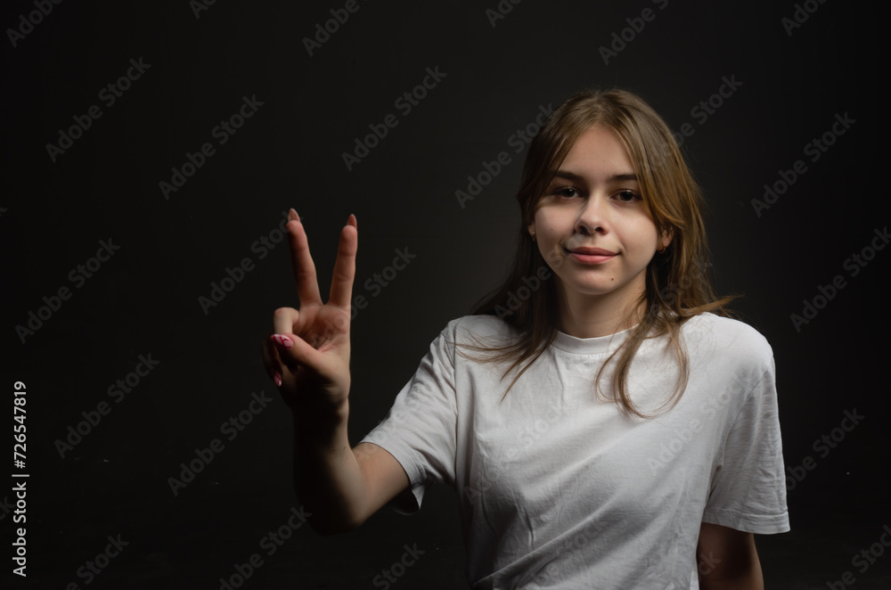 Girl in white t-shirt on dark background Girl in white t-shirt on dark background