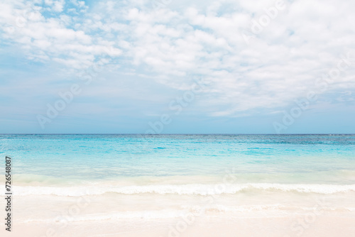 Beautiful white sand beach with turquoise water and blue sky with clouds in Punta Cana, Dominican Republic.