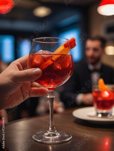 Photo Of Guests Sit At Table In Restaurant And Drink Bright Red Negroni Cocktail