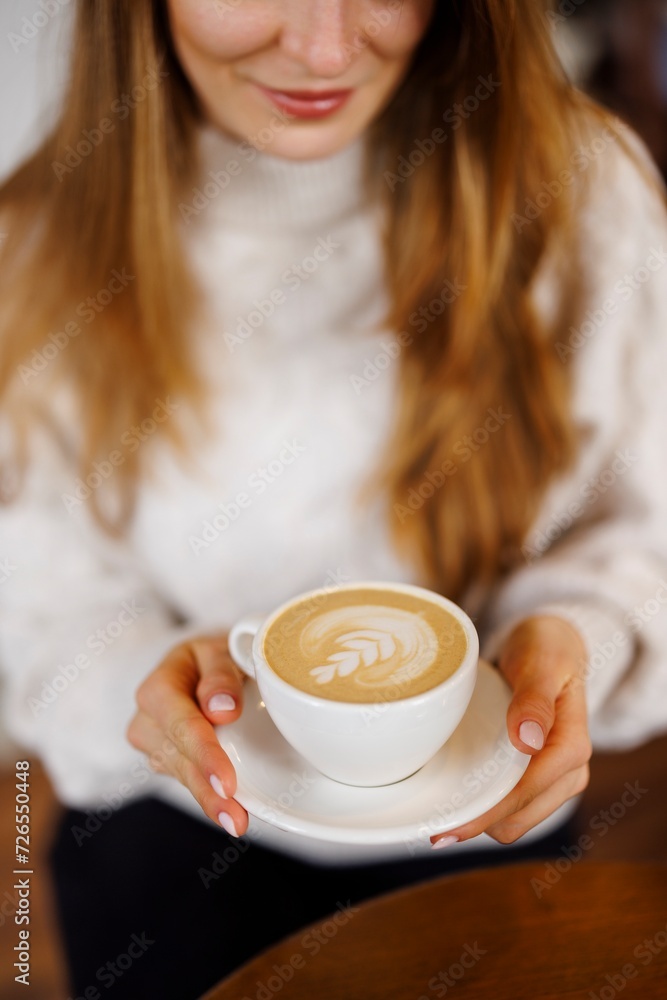 Closeup of a beautiful woman drinking cappuccino Closeup of a beautiful woman drinking cappuccino