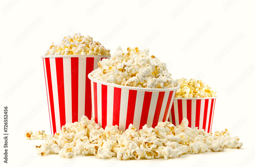Fototapeta premium Popcorn buckets in a big pile of popcorn isolated on white background