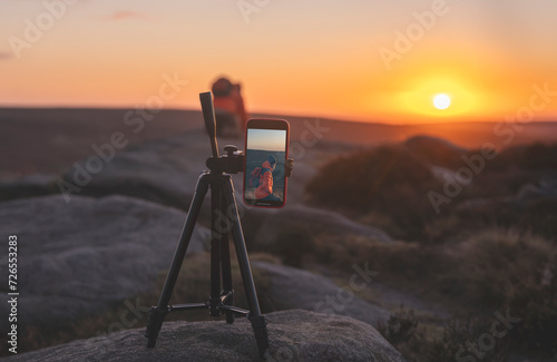 phone on a tripod taking photos or video of a landscape at sunrise  or sunset in Peak District photo