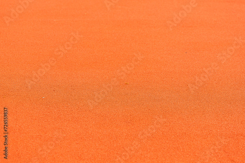 Close-up of orange rubber running surface on court texture