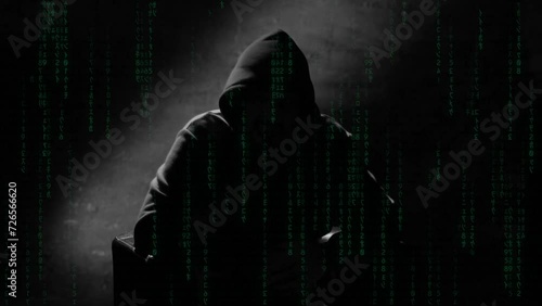 Anonymous man in a hood interview video footage, mysterious man sitting on a chair and talking. Anonymous hacker interview with no visible face footage, computer hacker conceptual background
