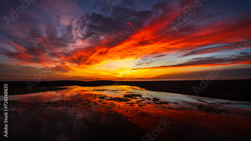 A rich colourful sunrise over the laguna at Vera Playa, Almeria, Spain