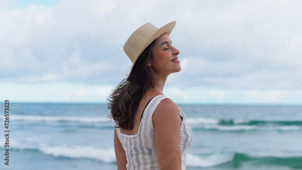 Happy young white woman wearing hat feeling the sea breeze. Beautiful smiling girl relaxing and enjoy the sun at seaside.
Happy young white woman wearing hat feeling the sea breeze. Beautiful smiling girl relaxing and enjoy the sun at seaside.
