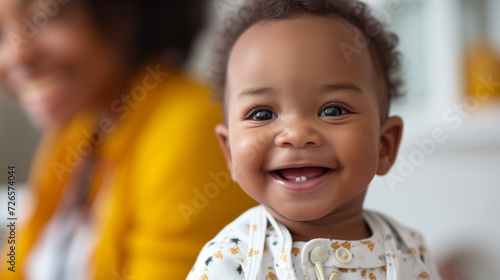 Happy black toddler boy. Smiling with his first two bottom baby teeth.