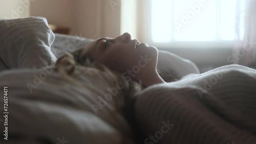 Portrait of sad young woman falls on the bed suffering from depression anxiety loneliness or mental health problem at home Thoughtful female upset feeling stress and pressure indoors