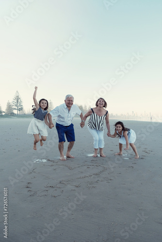 Happy multicultural grandparent with grandchildren on the beach photo